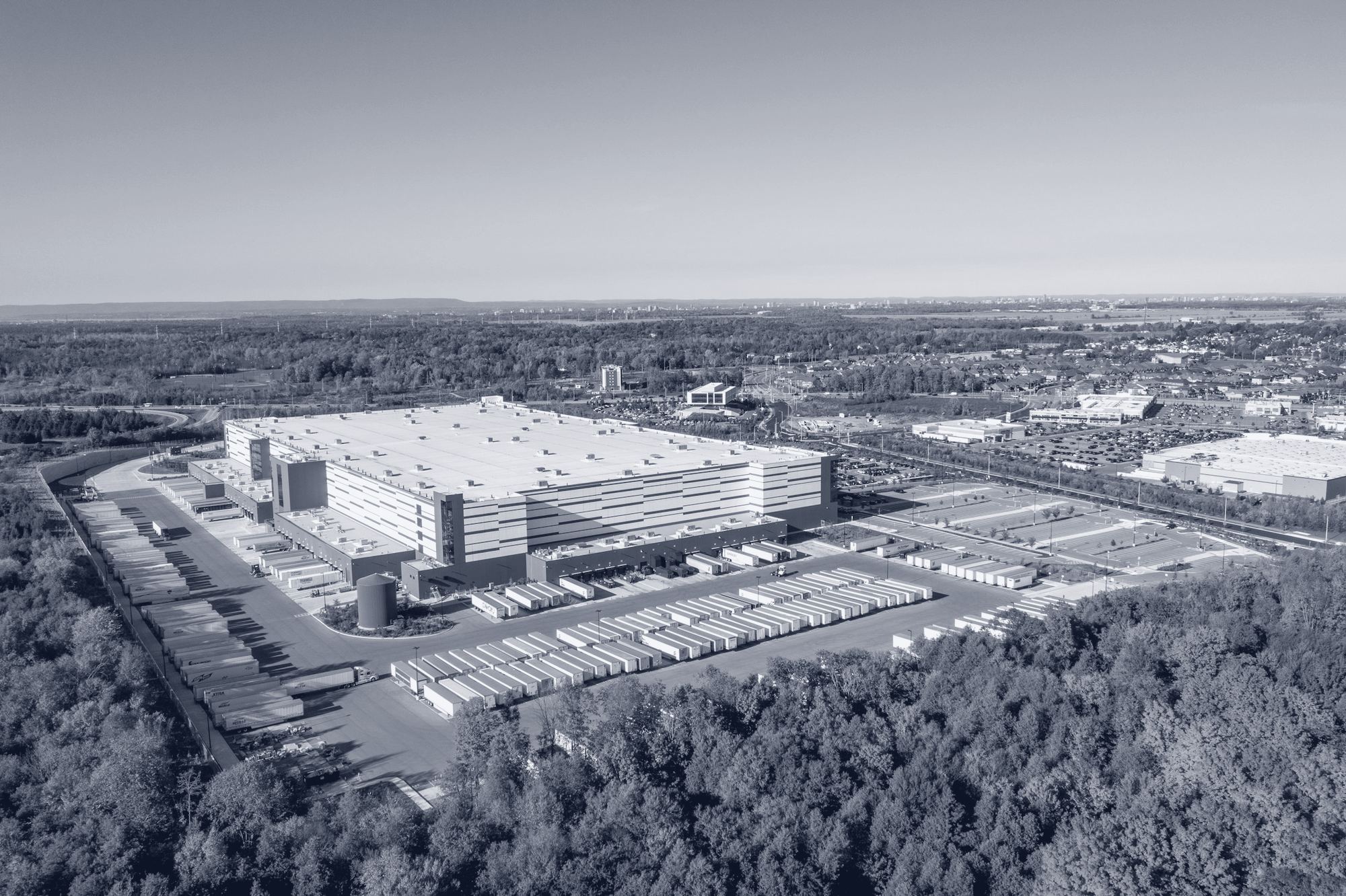 Aerial view of a modern logistics park surrounded by woodland